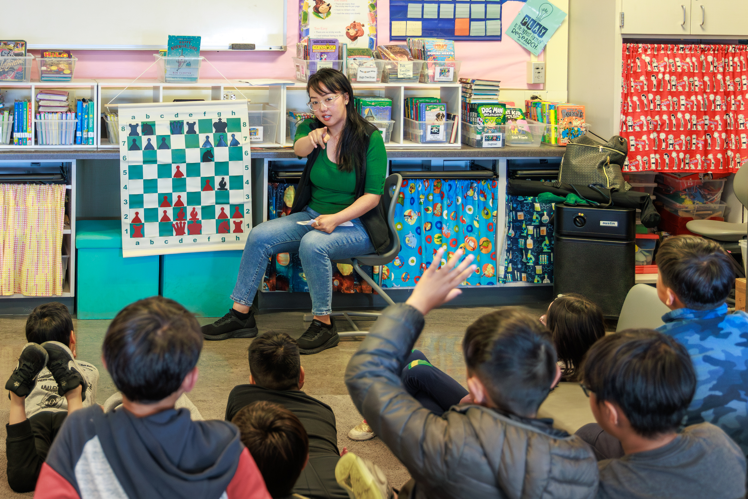 Chess coach teaching at school with kids i